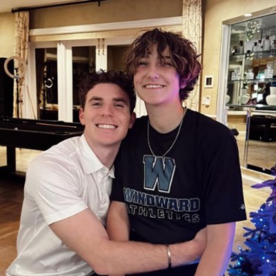 Collette Dubrow and his elder brother, Nick Dubrow, smiling together at the camera.